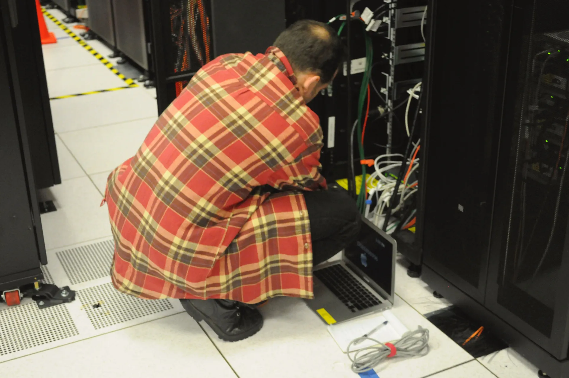Technician working on a server rack for the Dell Server SSH security guide